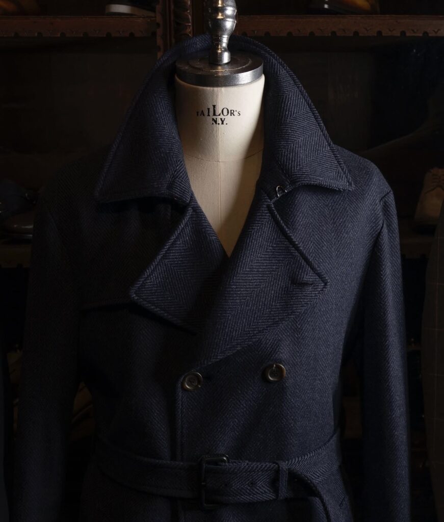 A well-dressed man wearing winter tailoring and an overcoat
