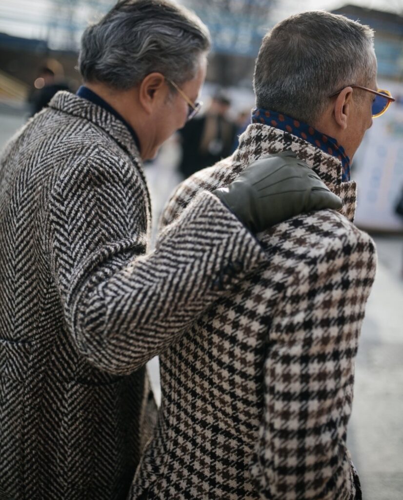 A tailored overcoat worn over a suit in cold weather