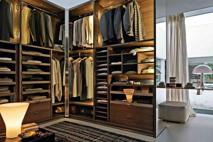 An organized men’s wardrobe with suits, shirts, and shoes arranged neatly